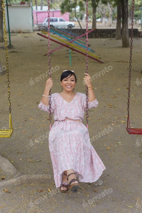 Preview: Woman swinging in an outdoor park.