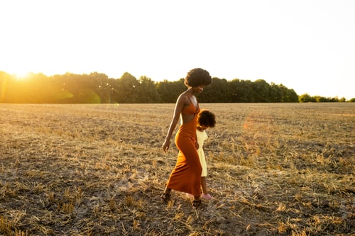 Preview: Beautiful mom and daughter in a sunflowers field