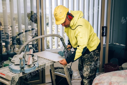 Preview: Master cuts the tile using an angle grinder with special diamond disc.