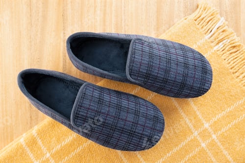 Preview: Male home slippers and wool blanket on table