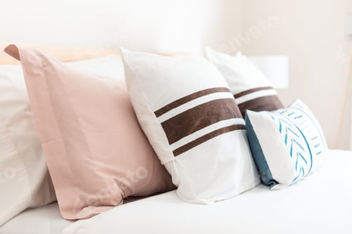 Preview: White bed with pink and blue, brown striped pillows