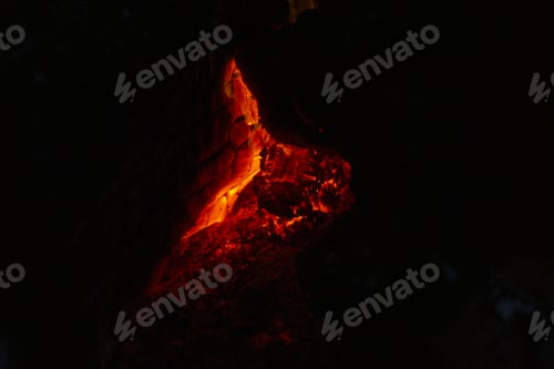 Preview: Beautiful closeup shot of bright red burning lava on a black background
