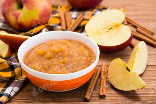 Preview: Apple puree, apples and cinnamon on a wooden table