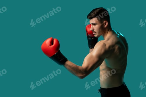 Preview: Male Boxer Preparing for Punch on Isolated Studio Background