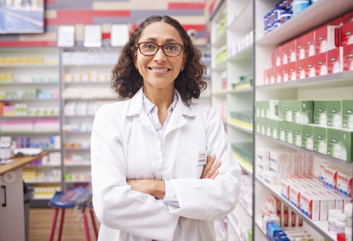 Preview: Pharmacy stock, medicine shelf and portrait of a woman pharmacist ready for work. Pharmaceutical st