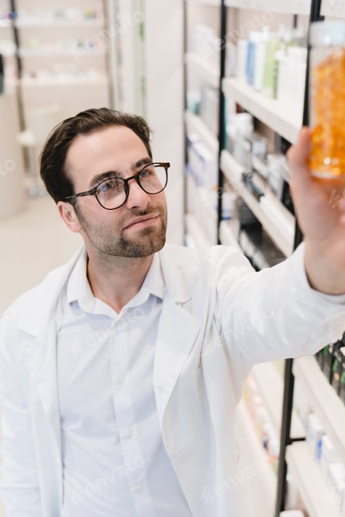 Preview: Druggist stretching to pills, vitamins, painkillers, medicines at pharmacy shelves in drugstore