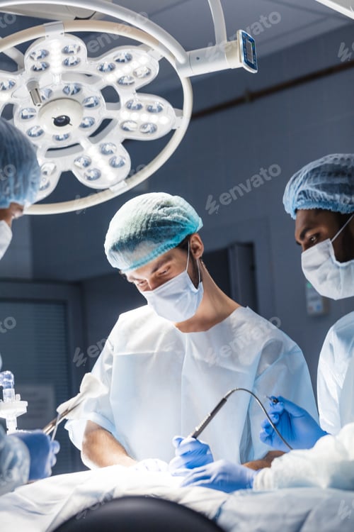 Preview: Young doctor, surgeon wearing medical protective mask in operating room