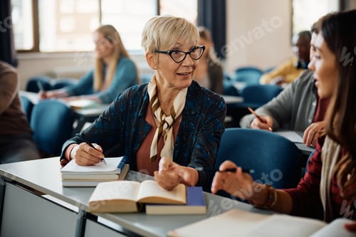 Preview: Female adult learners communicating during a class in lecture hall.