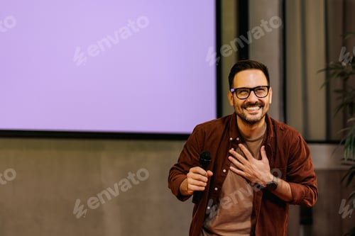 Preview: The happy man finishes a presentation, feeling thankful to the audience.