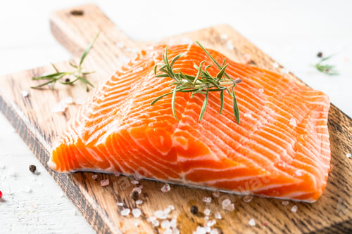 Preview: Uncooked salmon fillet with lemon sea salt and rosemary on white