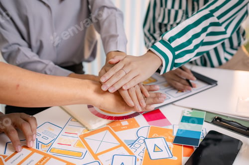 Preview: Designers having a UX/UI planning meeting to refine mobile app layouts and user flow.