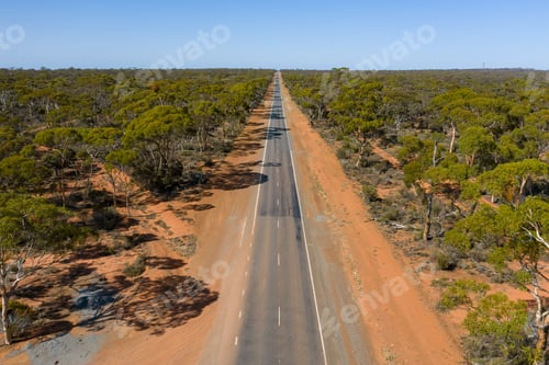 Preview: Aerial low angle view of a long straight road in the Australian outback in Western Australia