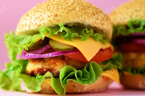 Preview: Macro view of tasty burger with beef, cheese, lettuce, onion, tomatoes on yellow background. Close
