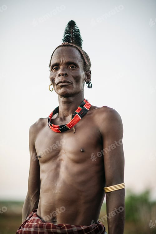 Preview: Proud stance of a tribal man in traditional attire
