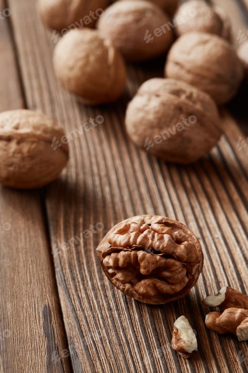 Preview: Walnuts and kernels on a dark rusty wood backdrop