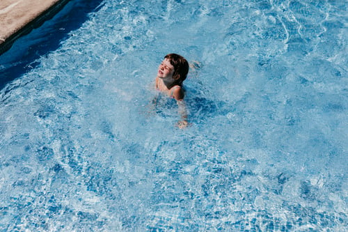 Preview: beautiful kid girl at the pool swimming and having fun. fun outdoors. Summer