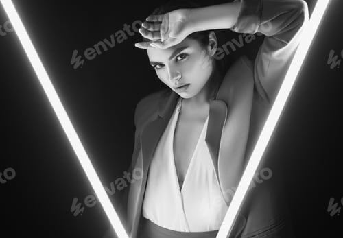 Preview: Portrait Of Elegant Beautiful Woman In A Fashionable Suit Posing Around Glowing Neon Lights