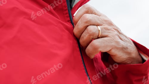 Preview: Hand Of A Man Unzipping The Raincoat