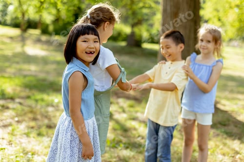 Preview: Group of asian and caucasian kids having fun in the park