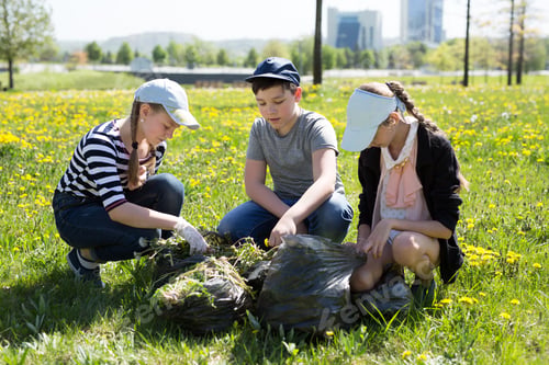 Preview: Close-up view of teenagers with gloves and garbage bags walking. Ecology protection concept.