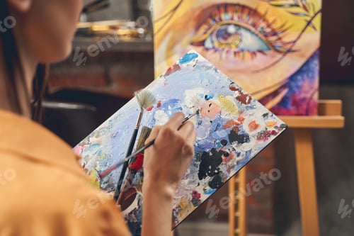 Preview: Talented female artist painting picture at home