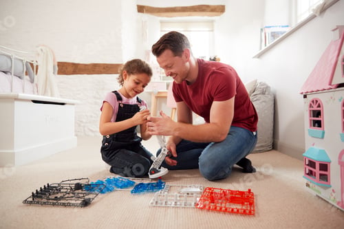 Preview: Father And Daughter In Bedroom Building Robot Kit Together