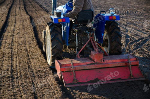 Preview: A farmer on a tractor cultivates a farm field. Softening the soil and preparing for cutting rows