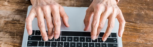 Preview: top view of senior woman typing on laptop at home