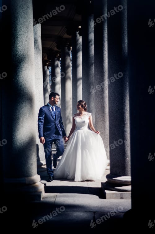 Preview: Newlyweds walking near columns