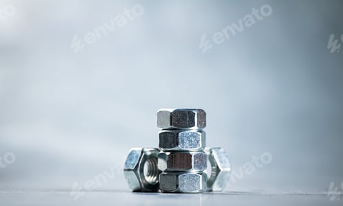 Preview: Working tool. Metal nuts on the table.