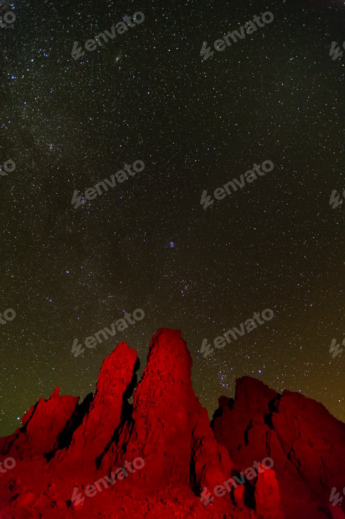 Preview: Starry night sky over jagged red rocks