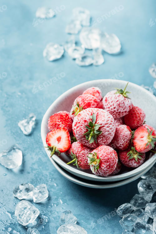 Preview: Frozen Strawberries in Bowl with Ice on Blue