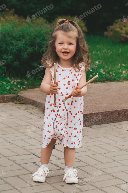 Preview: A cheerful girl catches soap bubbles with her hands and laughs. Happy childhood, summer time. Portra