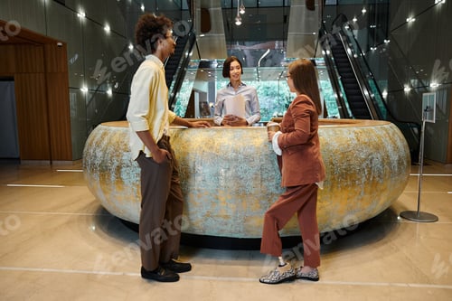 Preview: Multicultural colleagues chatting in office lobby