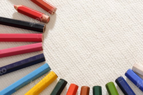 Preview: Closeup of a set of colored pencils on white canvas