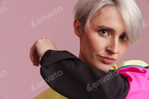 Preview: White-haired woman posing in multicolored jacket