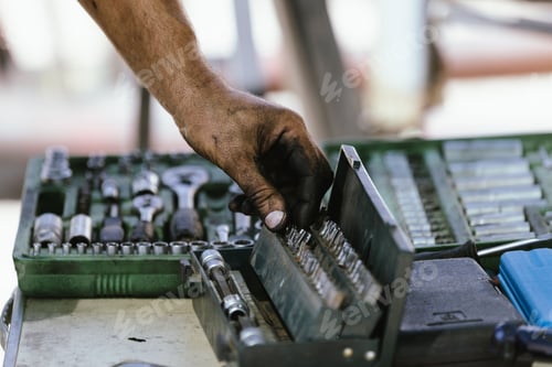 Preview: Hand of a mechanic choosing the tool he needs
