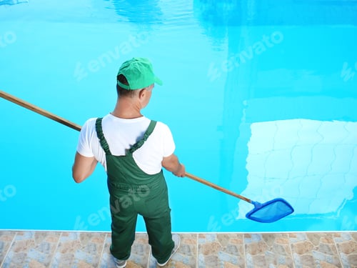 Preview: Male worker cleaning outdoor pool with scoop net