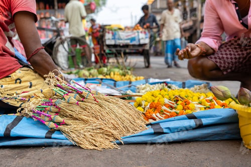Preview: Brooms, offerings, and flowers at a street market