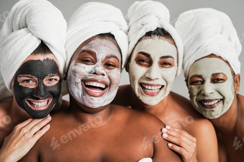 Preview: Multigenerational women having fun wearing face beauty masks for skin care therapy