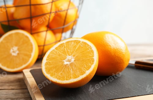 Preview: Fresh juicy oranges on cutting board. Healthy fruit
