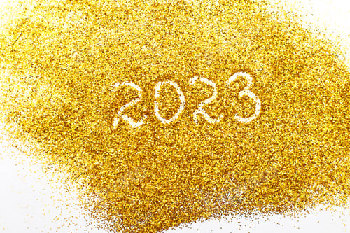 Preview: number 2023 written on golden confetti. christmas or new year background