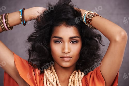 Preview: Studio portrait of a beautiful young fashion model posing against a gray background