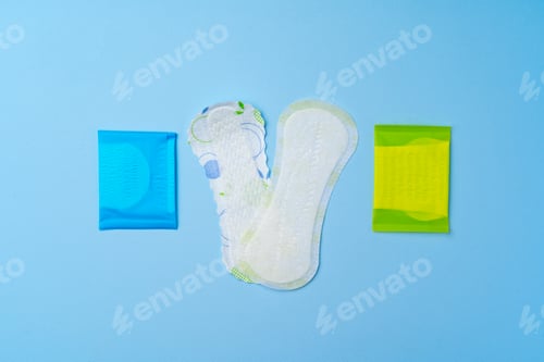 Preview: Female hygienic pad and tampons on blue background