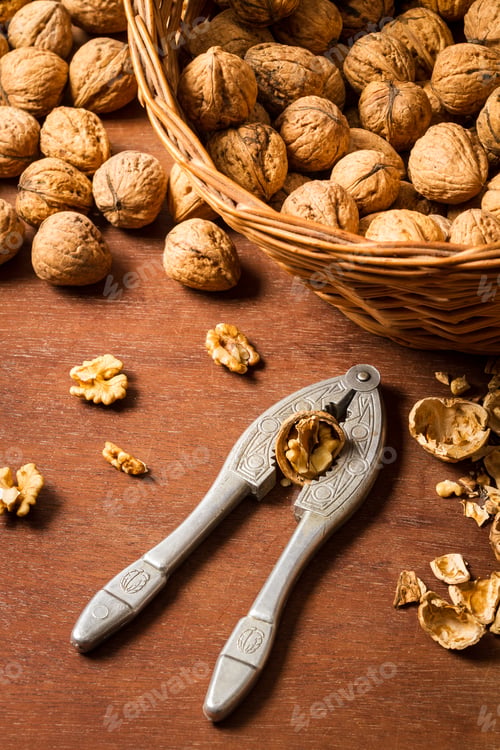 Preview: Cracking walnuts on old wooden table