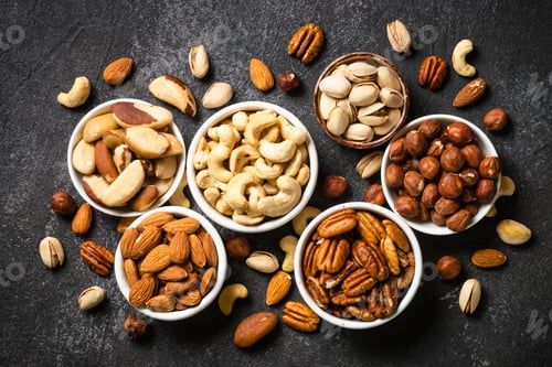 Preview: Assortment of nuts in bowls. Cashew, hazelnuts, pecan, almonds, brazilian nuts and pistachios.