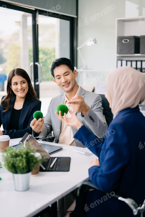 Preview: Group of diverse multiethnic businesspeople standing neare table looking at model of building