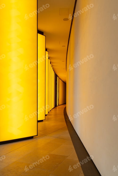 Preview: Vertical shot of the illuminated narrow hallway in a modern building