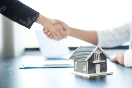 Preview: Businessmen and brokers real estate agents shake hand after completing negotiations to buy houses