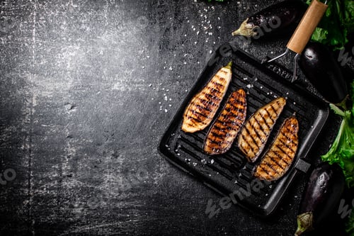 Preview: Slices of eggplant in a grill pan.